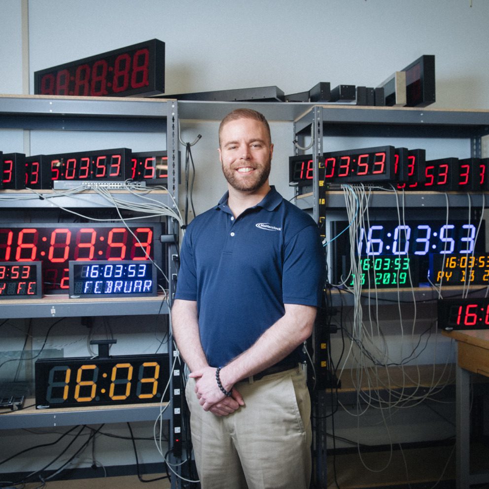 Masterclock CEO John Clark examines a time-keeping device.