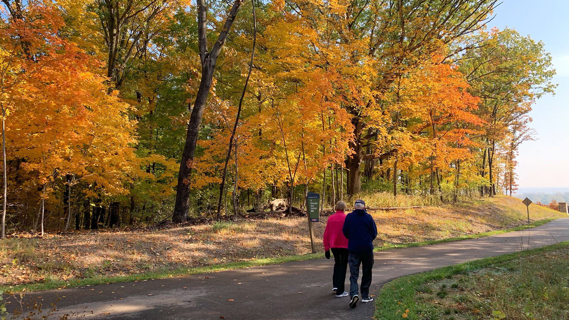 Couple walks one of the paved trails of Cliff Cave Park, in South St. Louis County.